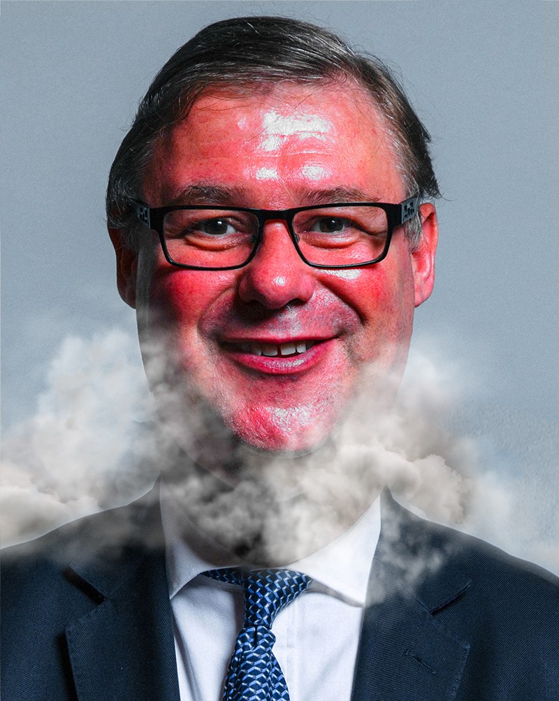 The Conservative Member of Parliament Mark Francois with a puffing red face and smoke coming out of his suit.