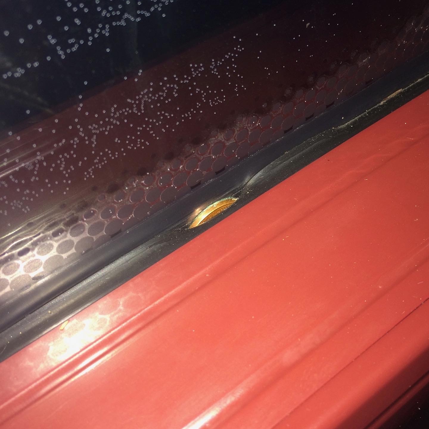 A coin jammed inside that rubbery line by the bus window.
